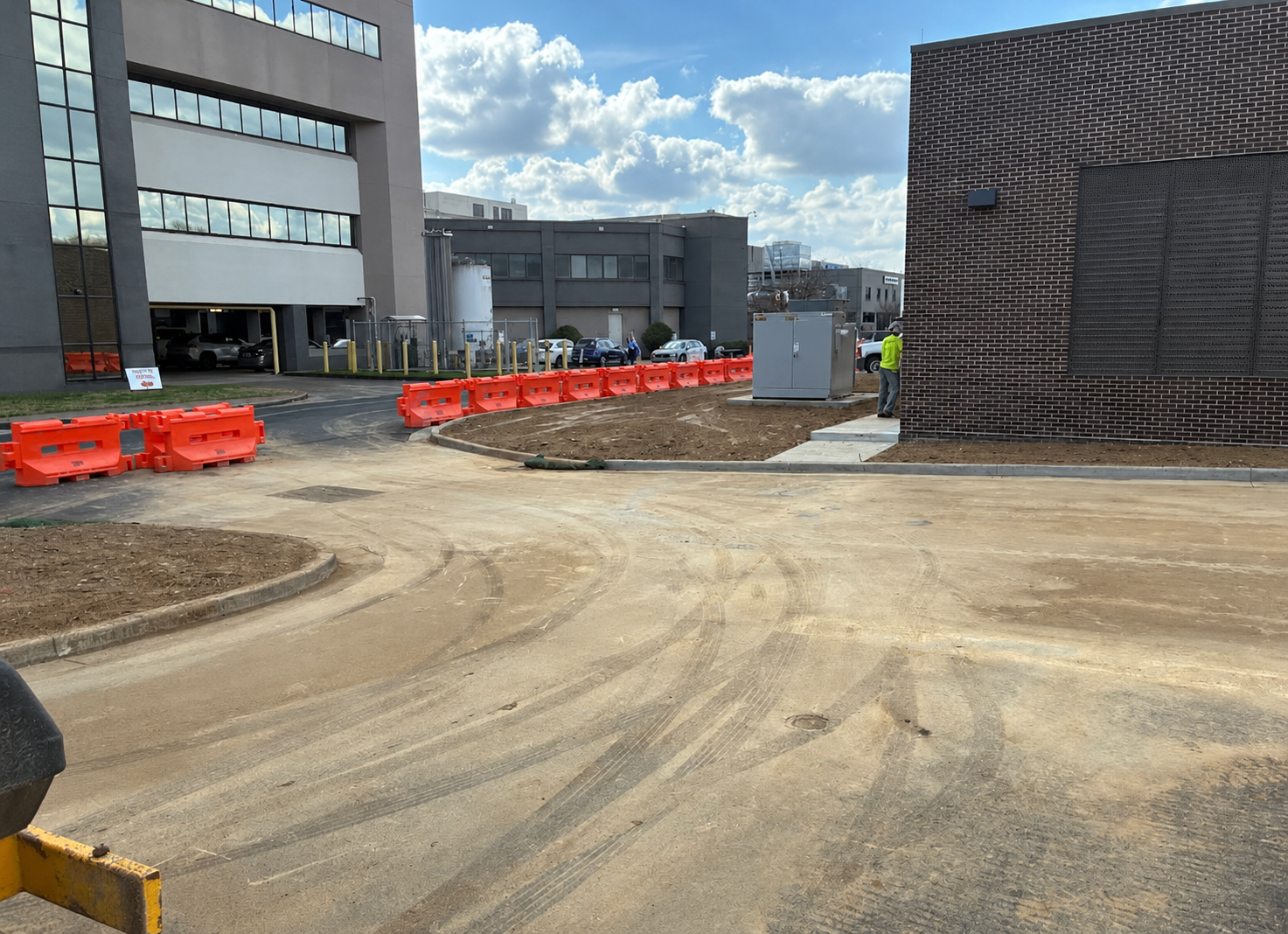 Before: muddy commercial parking lot covered in construction dirt